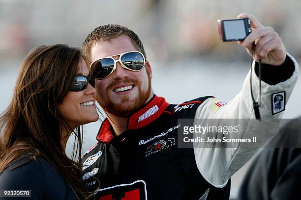 Robert Richardson Jr. , driver of the Mahindra takes a picture with a fan on the grid during qualifying for the NASCAR Nationwide series Kroger 'On...