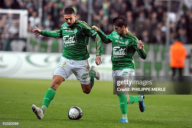 Saint-Etienne French defender Cedric Varrault runs with the ball next to teammate Belgian forward Kevin Mirallas during the French L1 football match...