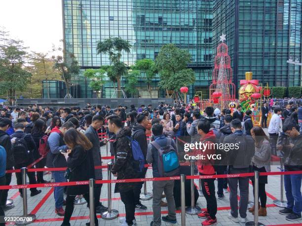 Employees of Chinese Internet giant Tencent queue up to get red envelops from Tencent Chairman and CEO Pony Ma Huateng at the headquarters of Tencent...
