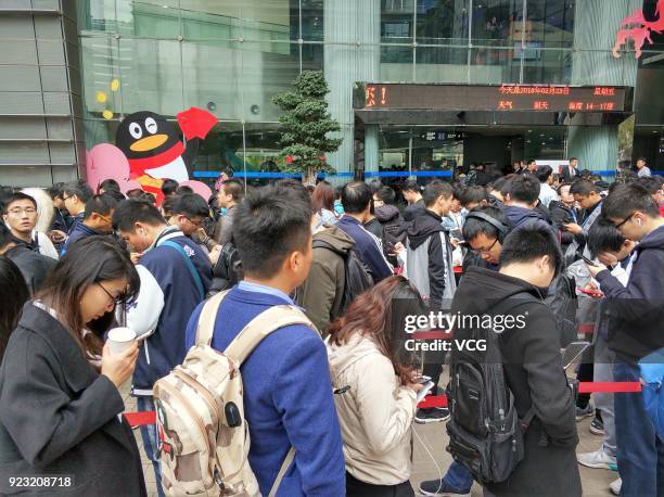 Employees of Chinese Internet giant Tencent queue up to get red envelops from Tencent Chairman and CEO Pony Ma Huateng at the headquarters of Tencent...