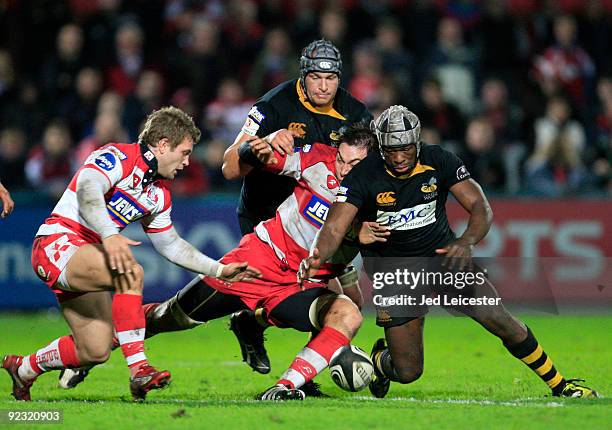 Serge Betsen of Wasps muscles his way through past Gareth Delve and Dave Lewis to get the ball during the Guinness Premiership match between...