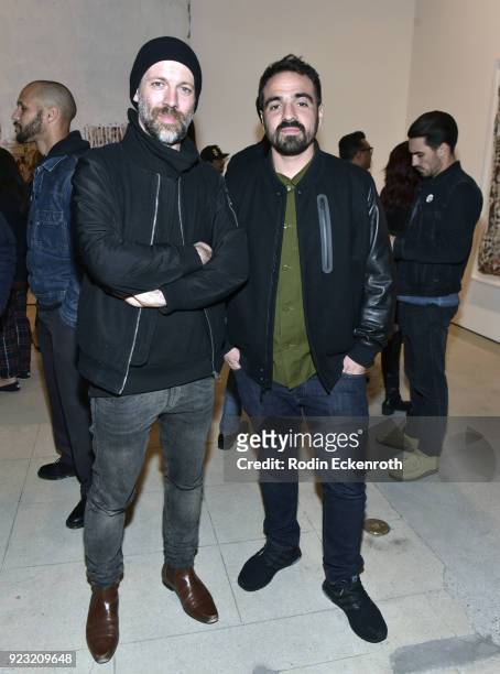 S Falk Lehmann and artist Alexandre Farto aka Vhils pose for portrait at the opening reception for Vhil's "Annihilation" exhibit at Over The...