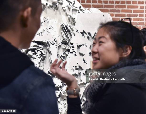 Attendees enjoy art at the opening reception for Vhil's "Annihilation" exhibit at Over The Influence on February 22, 2018 in Los Angeles, California.