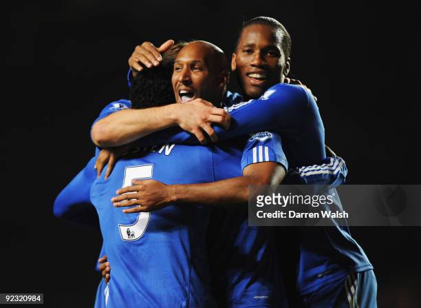 Michael Essien of Chelsea celebrates with Nicolas Anelka and Didier Drogba as he scores their third goal during the Barclays Premier League match...