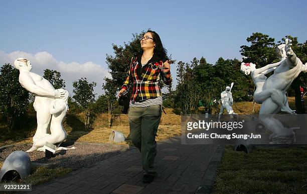 Woman enjoys at theme park 'Love Land' on October 24, 2009 in Jeju, South Korea. Love Land is an outdoor sex-themed sculpture park which opened in...