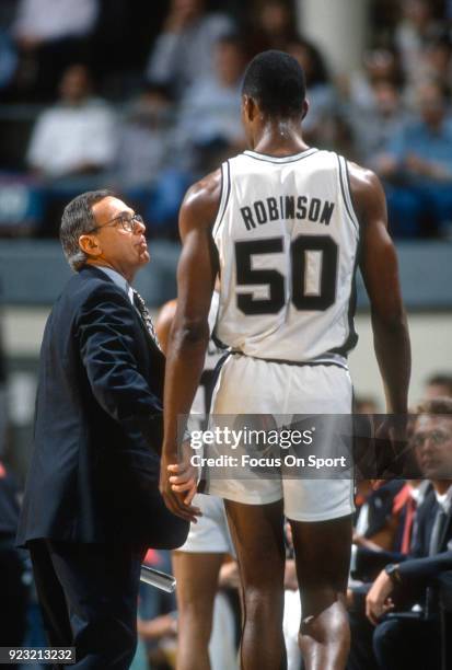 Head coach Larry Brown of the San Antonio Spurs talks with his player David Robinson during an NBA basketball game circa 1989 at HemisFair Arena in...