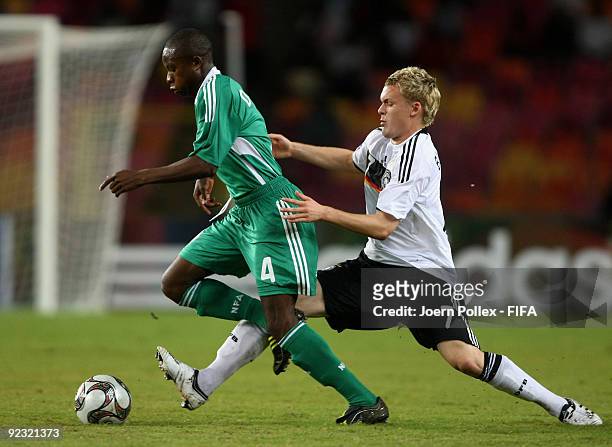Christopher Buchtmann of Germany and Ogenyi Onazi of Nigeria battle for the ball during the FIFA U17 World Cup Group A match between Nigeria and...