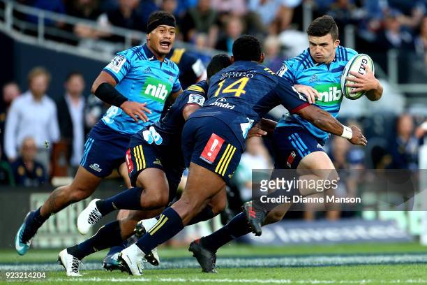 Bryn Gatland of the Blues fends off Waisake Naholo of the Highlanders during the round two Super Rugby match between the Highlanders and the Blues at...