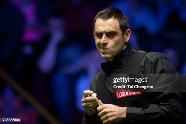 Ronnie O'Sullivan of England chalks the cue during his second round match against Xiao Guodong of China on day four of 2018 Ladbrokes World Grand...