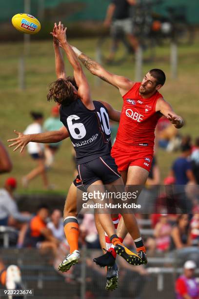 Lachie Whitfield and Matt Flynn of the Giants compete for the ball with Sam Naismith of the Swans during the AFL Inter Club match between the Sydney...