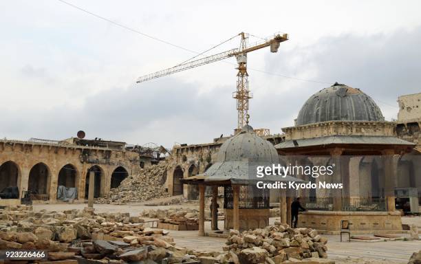 Photo taken in the old city area of Aleppo, northern Syria, on Feb. 21, 2018 shows the Umayyad Mosque with building stone to be used to restore the...