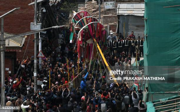 Nepali devotees erect the ceremonial bamboo pole know as a 'Chir', fringed with strips of cloth representing good luck charms, to mark the beginning...