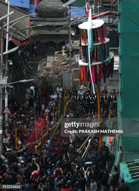 Nepali devotees erect the ceremonial bamboo pole know as a 'Chir', fringed with strips of cloth representing good luck charms, to mark the beginning...