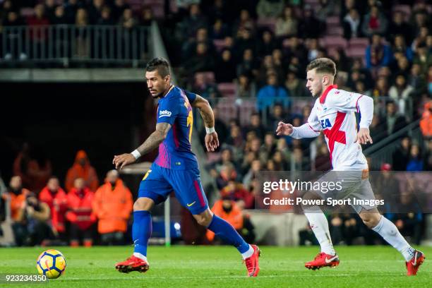 Jose Paulo Bezerra Maciel Junior, Paulinho, of FC Barcelona is followed by Alvaro Medran of Deportivo Alaves during the La Liga 2017-18 match between...