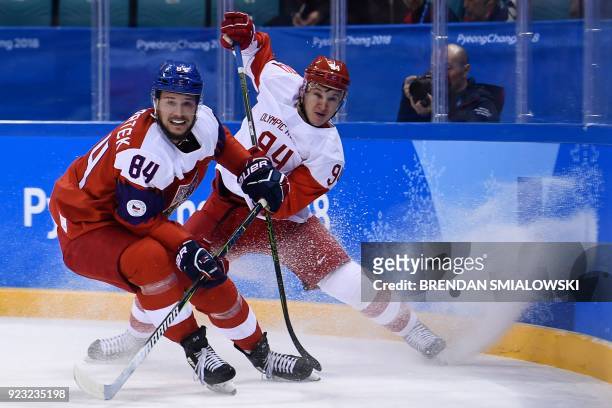 Czech Republic's Tomas Kundratek and Russia's Alexander Barabanov fight for the puck in the men's semi-final ice hockey match between the Czech...