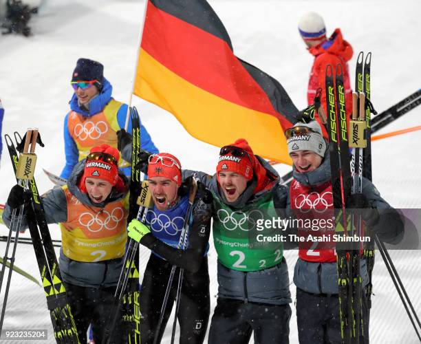 Johannes Rydzek of Germany, Vinzenz Geiger of Germany, Fabian Riessle of Germany and Eric Frenzel of Germany celebrate winning the gold medal after...