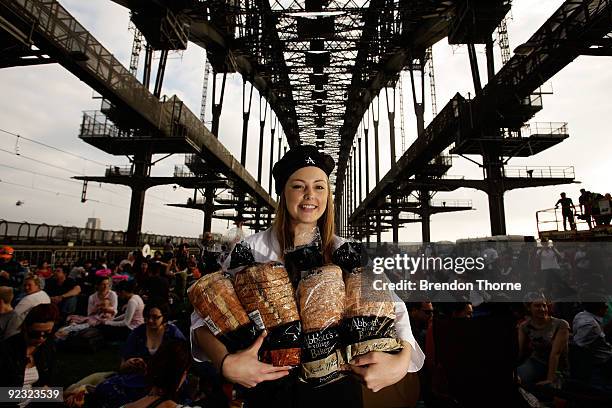 Women poses while handing out bread during a picnic breakfast on the Sydney Harbour Bridge on October 25, 2009 in Sydney, Australia. For the first...