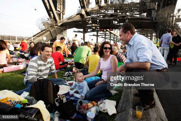 Premier Nathan Rees hands out food to a family during a picnic breakfast on the Sydney Harbour Bridge on October 25, 2009 in Sydney, Australia. For...