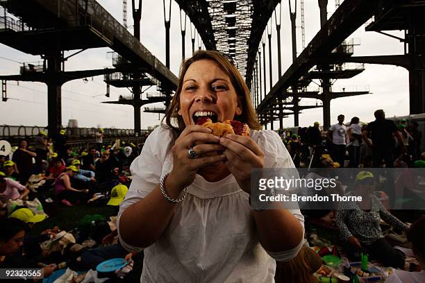 Women eats a croissant during a picnic breakfast on the Sydney Harbour Bridge on October 25, 2009 in Sydney, Australia. For the first time in its...