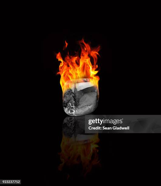 ice cube on fire - fire transparent stock pictures, royalty-free photos & images