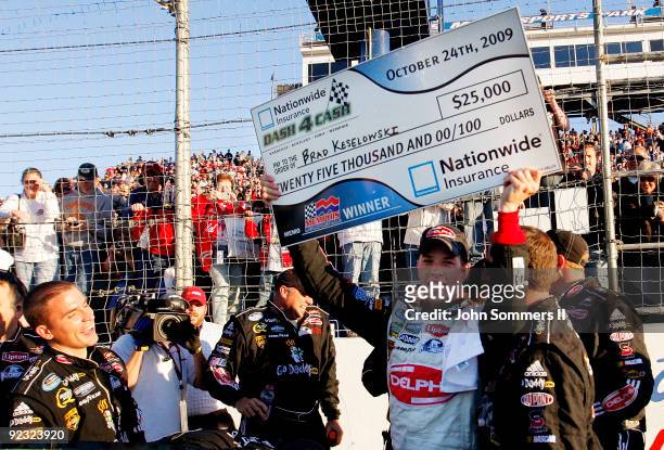 Brad Keselowski, driver of the Delphi Chevrolet celebrates winning the NASCAR Nationwide series Kroger 'On Track For Cure' 250 race at the Memphis...