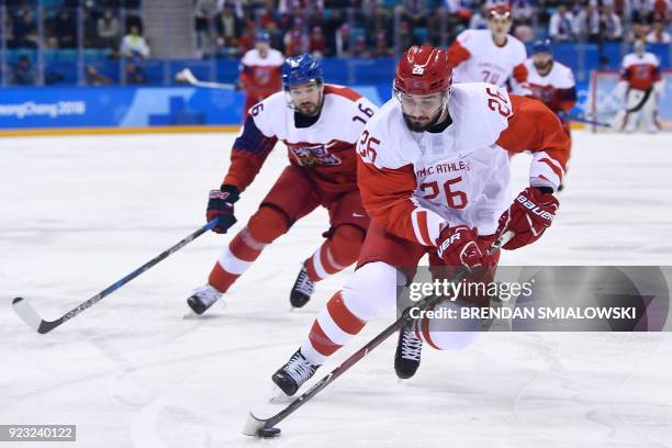 Russia's Vyacheslav Voinov controls the puck in front of Czech Republic's Michal Birner in the men's semi-final ice hockey match between the Czech...