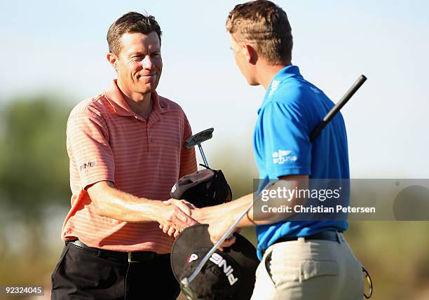 Nick O'Hern of Australia shakes hands with Chris Stroud on the 18th hole green following their third round of the Frys.com Open at Grayhawk Golf Club...