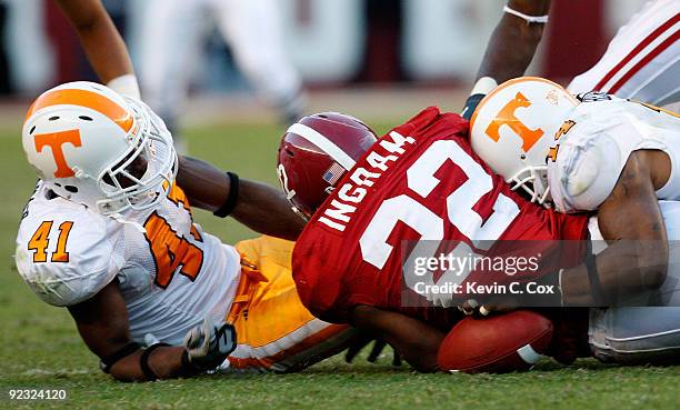 Dennis Rogan and Eric Berry of the Tennessee Volunteers force a fumble by Mark Ingram of the Alabama Crimson Tide at Bryant-Denny Stadium on October...