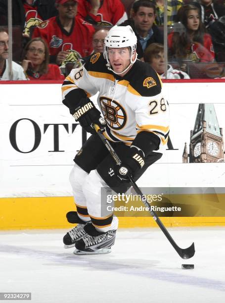 Mark Recchi of the Boston Bruins stickhandles the puck against the Ottawa Senators in his 1500th career NHL game at Scotiabank Place on October 24,...