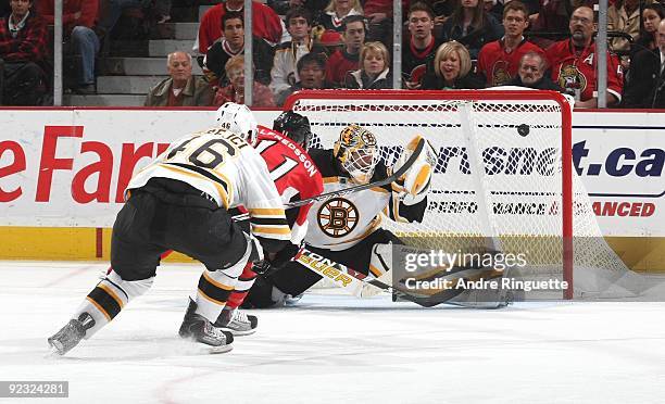 Daniel Alfredsson of the Ottawa Senators outskates David Krejci of the Boston Bruins and scores a short handed goal against Tim Thomas of the Boston...