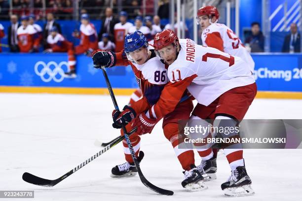 Czech Republic's Tomas Mertl and Russia's Sergei Andronov fight for the puck in the men's semi-final ice hockey match between the Czech Republic and...