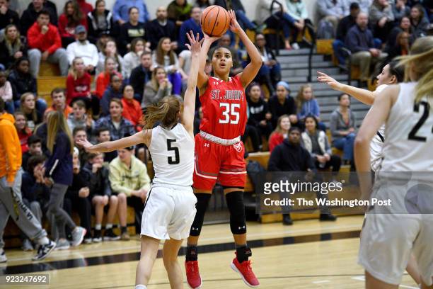 St. John's Cadets Azzi Fudd shoots for three around Paul VI Panthers guard Christina Green in the first half January 03, 2018 in Fairfax, VA. The St....
