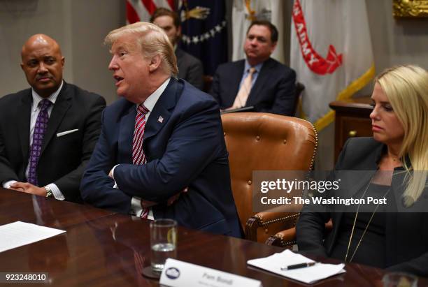 President Donald Trump makes a point during a conversation while seated next to Indiana Attorney General Curtis Hill, left, and Florida Attorney...