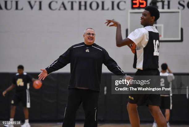 Paul VI's head coach Glenn Farello talks to Brandon Slater, right, after Slater released a shot during basketball practice at Paul VI High School on...