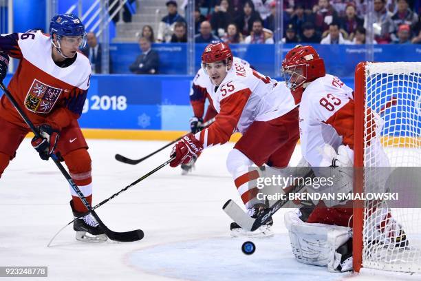 Russia's Vasili Koshechkin blocks a shot in front of Czech Republic's Tomas Mertl in the men's semi-final ice hockey match between the Czech Republic...