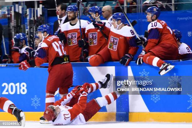 Russia's Kirill Kaprizov falls on the ice in front of the Czech Republic bench in the men's semi-final ice hockey match between the Czech Republic...