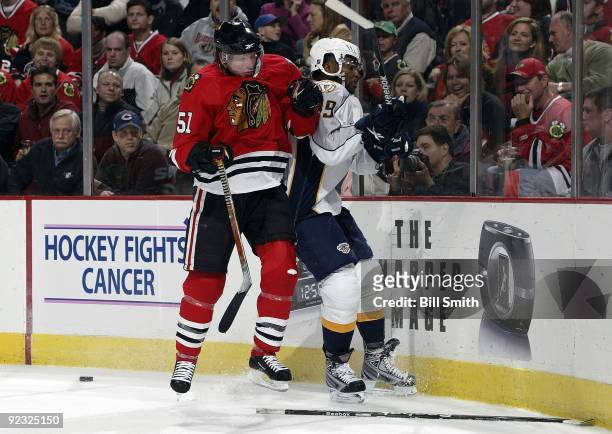 Brian Campbell of the Chicago Blackhawks pushes into Joel Ward of the Nashville Predators on October 24, 2009 at the United Center in Chicago,...