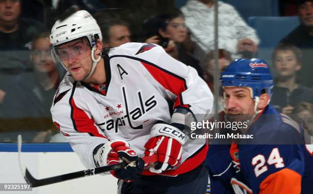 Alex Ovechkin of the Washington Capitals skates against Radek Martinek of the New York Islanders on October 24, 2009 at Nassau Coliseum in Uniondale,...