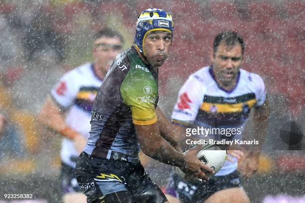 Johnathan Thurston of the Cowboys looks to pass during the NRL trial match and Jonathan Thurston/Cameron Smith Testimonial match between the...