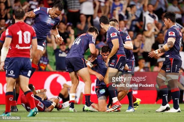 Tom English of the Rebels celebrates a try with teammates during the round two Super Rugby match between the Melbourne Rebels and the Queensland Reds...