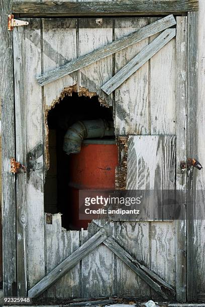 hole in the wall - broken door stock-fotos und bilder