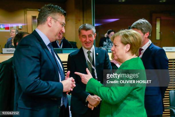 Germany's Chancellor Angela Merkel speaks with Croatia's Prime Minister Andrej Plenkovic as they arrive to attend a High Level Conference on the...