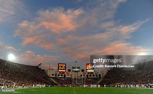Clouds over the Los Angeles Memorial Coliseum turn pink in color as the sun sets during the Oregon State Beavers and USC Trojans college football...