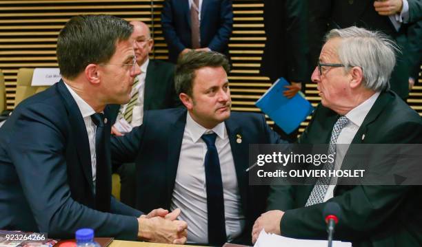 Netherland's Prime Minister Mark Rutte and Luxembourg's Prime Minister Xavier Bettel speak with European Commission President Jean-Claude Juncker as...