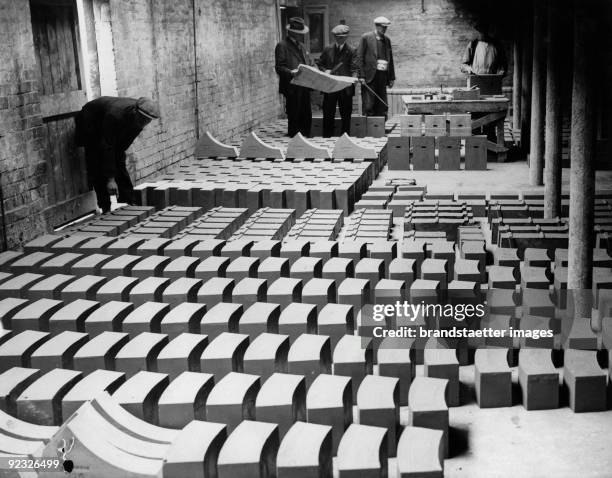 More than 600 tons of bricks are needed for the boiler of Queen Mary. Picture: Green claybricks - they aren't baked. Photograph. England. 1935.