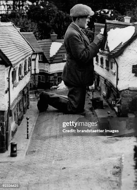 Painting colossus. A painter in "Bekonscot" is busy with the midget reproduction of Beaconsfield. England. 1937.