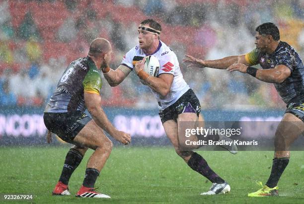 Tim Glasby of the Storm takes on the defence during the NRL trial match and Jonathan Thurston/Cameron Smith Testimonial match between the Melbourne...