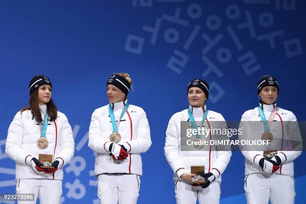 France's bronze medallists Anais Chevalier, Marie Dorin Habert, Justine Braisaz and Anais Bescond pose on the podium during the medal ceremony for...