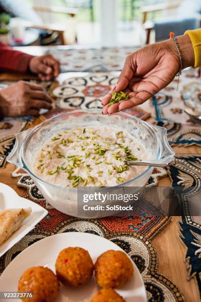 adding the finishing touches - ramadan dinner stock pictures, royalty-free photos & images