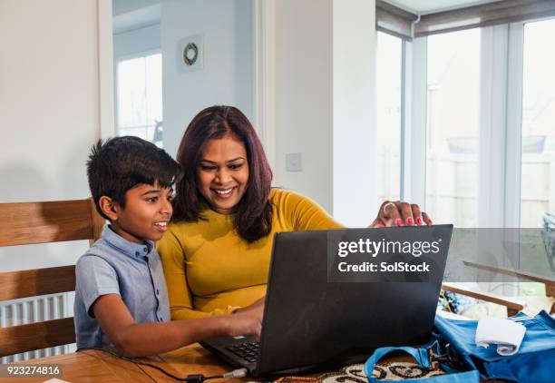 helping her son with his homework - daily life in bangladesh imagens e fotografias de stock